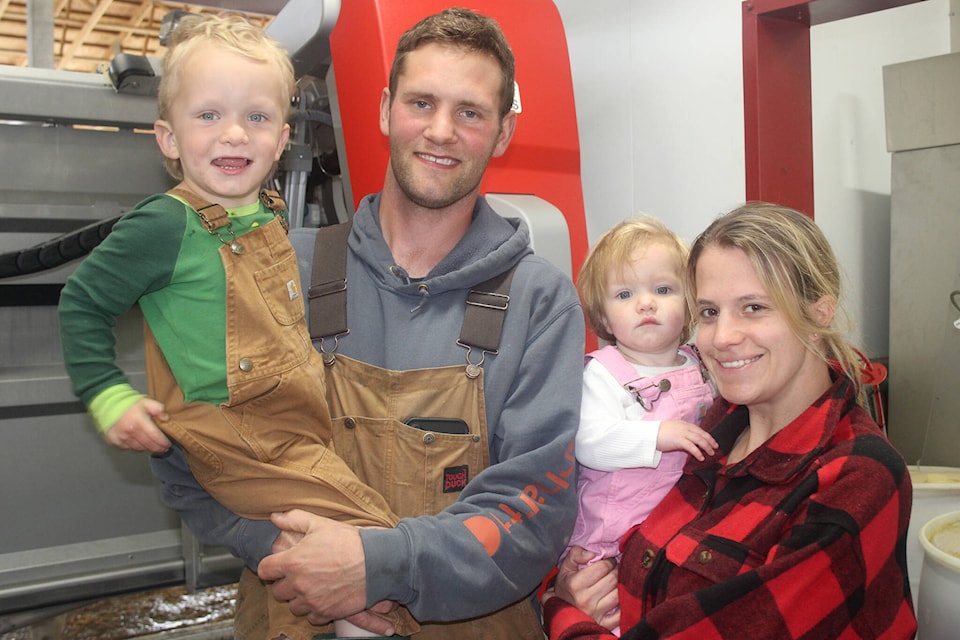 Left to right: Luke, David, Wellsley and Aimee Matlak in front of the robot. Patrick Penner / Mission Record