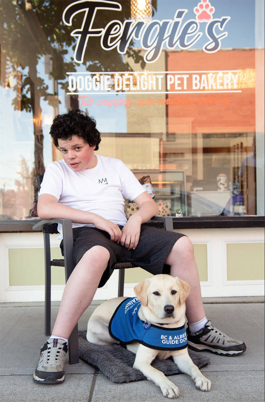 Ryder Newhouse, 15, met Juniper, an eight-month-old yellow Labrador with BC and Alberta Guide Dogs, in downtown Chilliwack on Friday, June 24. Ryder has been raising money to help pay for her training over the past six months. (Lorna Shaw photo)