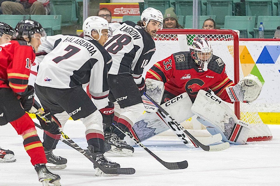 Vancouver Giants Ty Halaburda and Colton Langkow applied pressure to Cougars netminder Ty Young as the G-Men won won the first half of their two-game road weekend against Prince George Cougars at the CN Centre on Saturday, Nov. 12 5-4.(James Doyle/Special to Langley Advance Times)