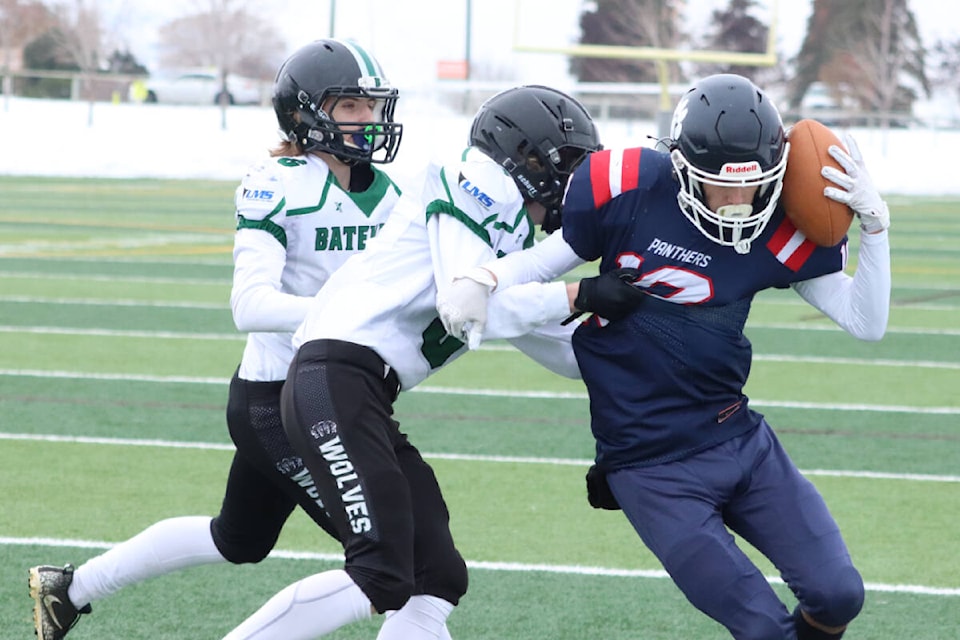 Vernon Panthers receiver Anderson Bicknell (right) keeps the ball pinned to his shoulder while being defended by Robert Bateman Timberwolves tacklers Jackson Kliewer (left) and Colton Marshall during the Panthers’ 35-14 win in the Subway Bowl B.C. AA Junior Varsity Football semifinal Wednesday, Nov. 23, at Greater Vernon Athletic Park. (Roger Knox - Black Press)