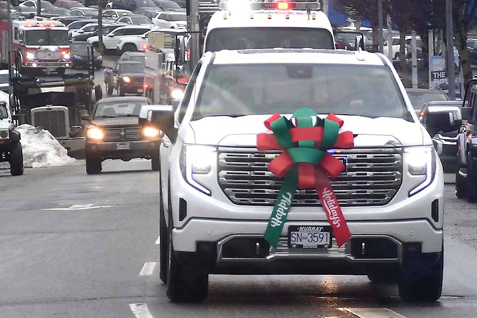 A convoy left the Fraser Valley Auto Mall and drove across town on Sunday (Dec. 18) to the Archway Food Bank to deliver food and cash donations collected over the prior weeks. (John Morrow/Abbotsford News)