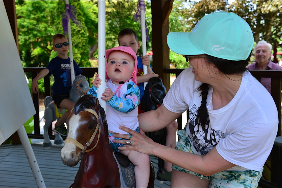 One of the youngest riders on The Springs RV Resort’s newly-restored carousel reacts to their very first ride in Harrison Hot Springs on Saturday, May 20. Area artist Annette Resler helped restore the antique ponies to working order, much to the delight of resort guests. (Photo/Annette Resler)
