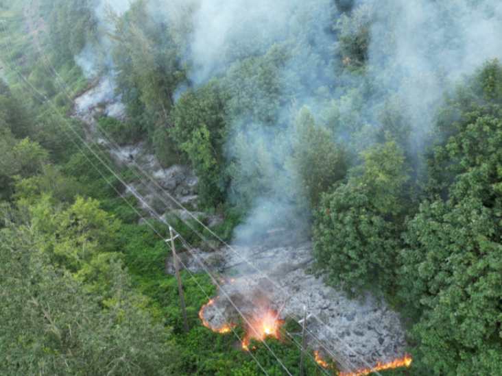 A wildfire burns near Highway 1 under hydro wires east of Agassiz on Monday morning. 