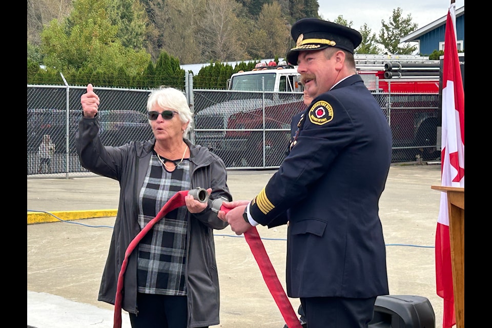 Kent Mayor Sylvia Pranger gives a thumbs up as a house uncoupling marks the opening of the new training facility at the Agassiz Fire Department 