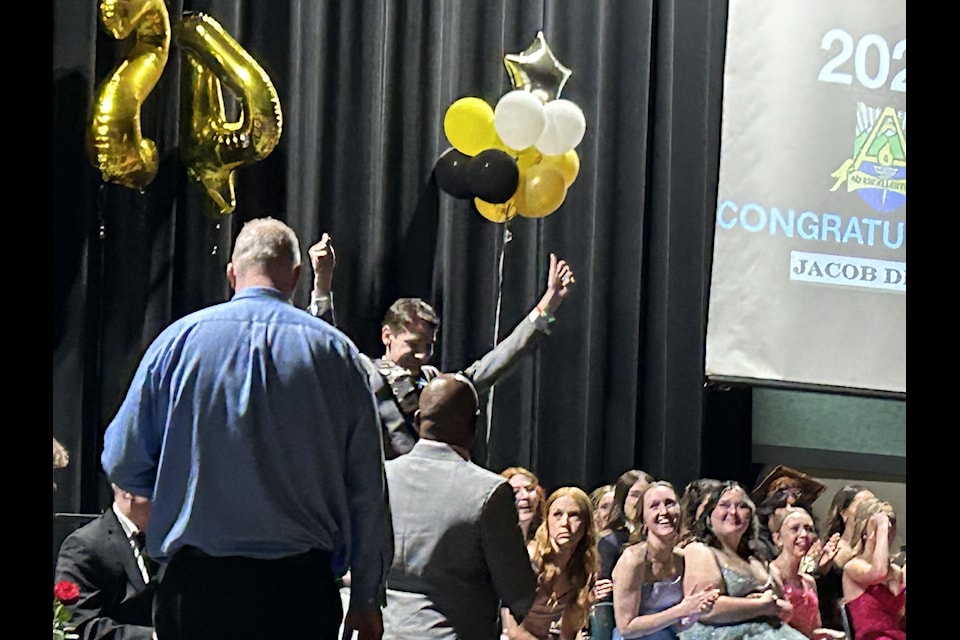 Jacob Dieno raises his hands in celebration during the 2024 AESS graduation ceremony. 