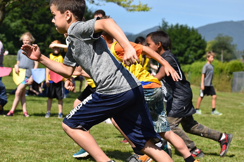 Grade 4 boys break from the starting line in the 100-metre race during the SD78 track and field day. (Grace Kennedy/The Observer)