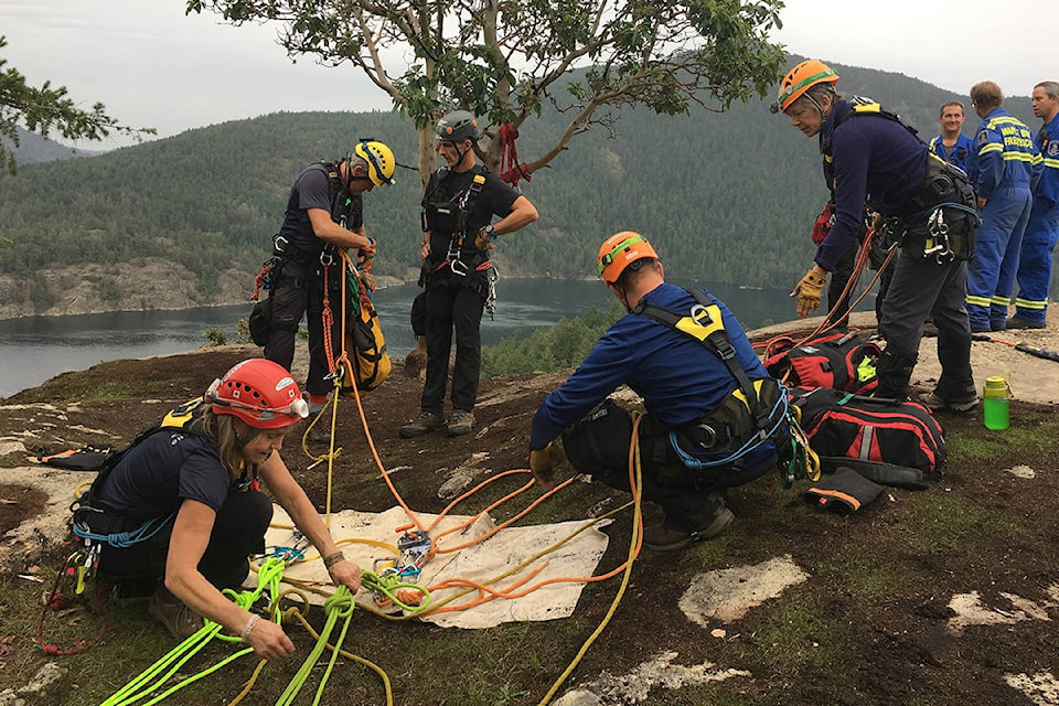The Cowichan Search and Rescue team prepares to head down the cliff face at Stoney Hill to try to find dog Frankie. (Warren Goulding/Citizen)