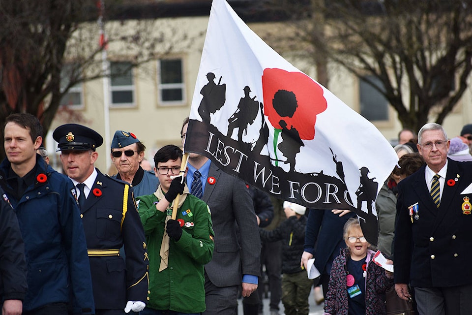 The parade marches down Highway 9 towards the cenotaph. (Grace Kennedy/The Observer)