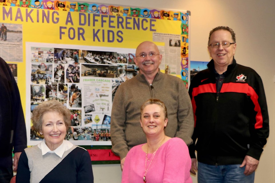 Koopman, right, beside fellow board members in front of a bulletin board he had installed. It read ‘making a difference for kids’ and proudly displayed all of the new programs and successes of programs in SD78 schools. Submitted photo