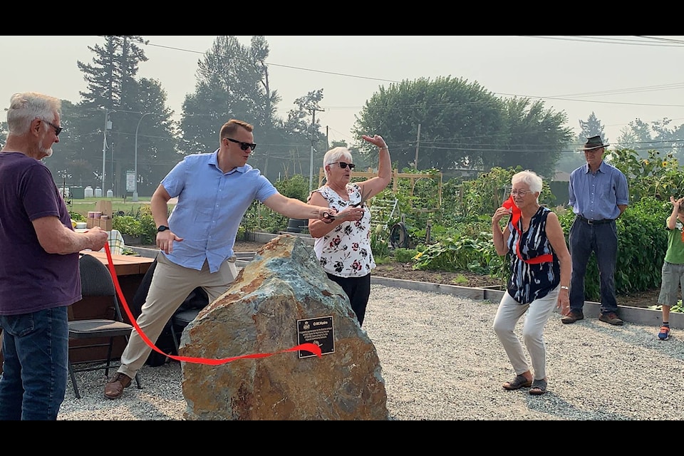 MP Brad Vis and District of Kent Mayor Sylvia Pranger celebrate as they jointly cut the ribbon at the Agassiz Community Garden on Saturday, Aug. 14. (Adam Louis/Observer)