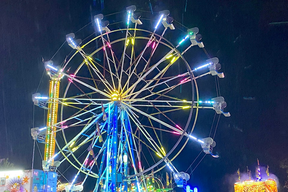 The lights of the Ferris wheel shine bright against the rain and night sky during the Agassiz Fall Fair and Corn Festival this weekend. (Photo/Laura Tunbridge)