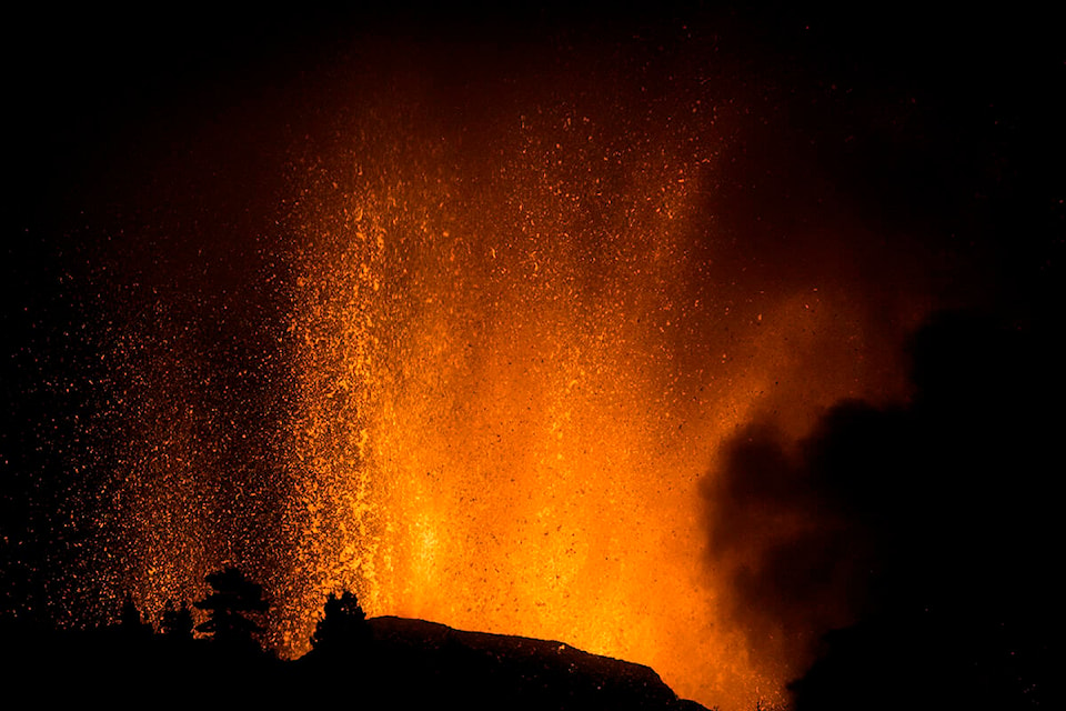 Lava flows from an eruption of a volcano at the island of La Palma in the Canaries, Spain, Sunday, Sept. 19, 2021. A volcano on Spain’s Atlantic Ocean island of La Palma erupted Sunday after a weeklong buildup of seismic activity, prompting authorities to evacuate thousands as lava flows destroyed isolated houses and threatened to reach the coast. New eruptions continued into the night. (AP Photo/Jonathan Rodriguez)