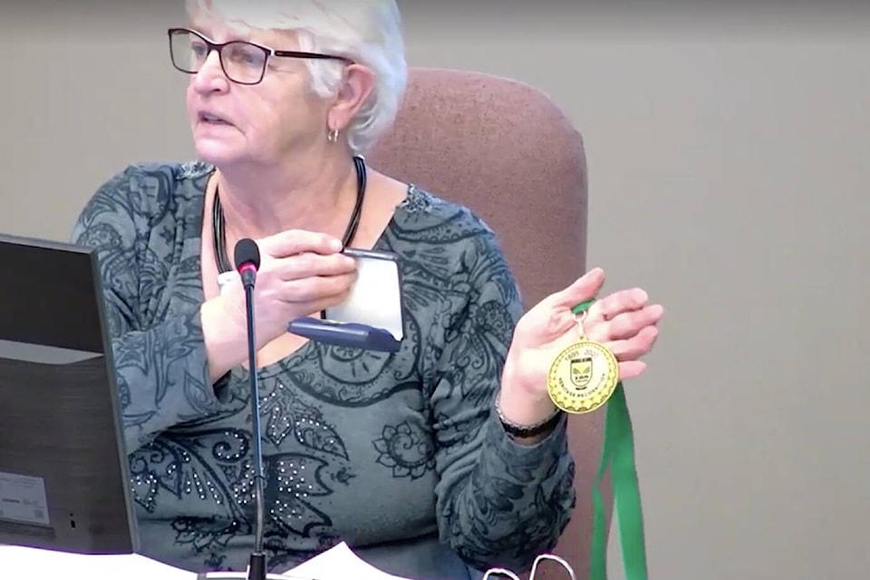 District of Kent Mayor Sylvia Pranger holds a commemorative medal, as presented to members of heritage families throughout the district and Seabird Island community. (Screenshot/District of Kent)