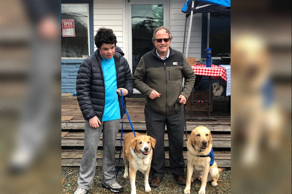 Ryer Newhouse and his unofficial guide dog Tommy pose with B.C. and Alberta Guide Dogs’ CEO William Thornton and his canine friend Felix during this weekend’s fundraiser. Ryder sold his treats to benefit B.C. and Alberta Guide Dogs during the grand opening of Beach Dogs Veterinary Walk-In Clinic on Saturday, April 2. (Contributed Photo/Laura Anne Sivilay)