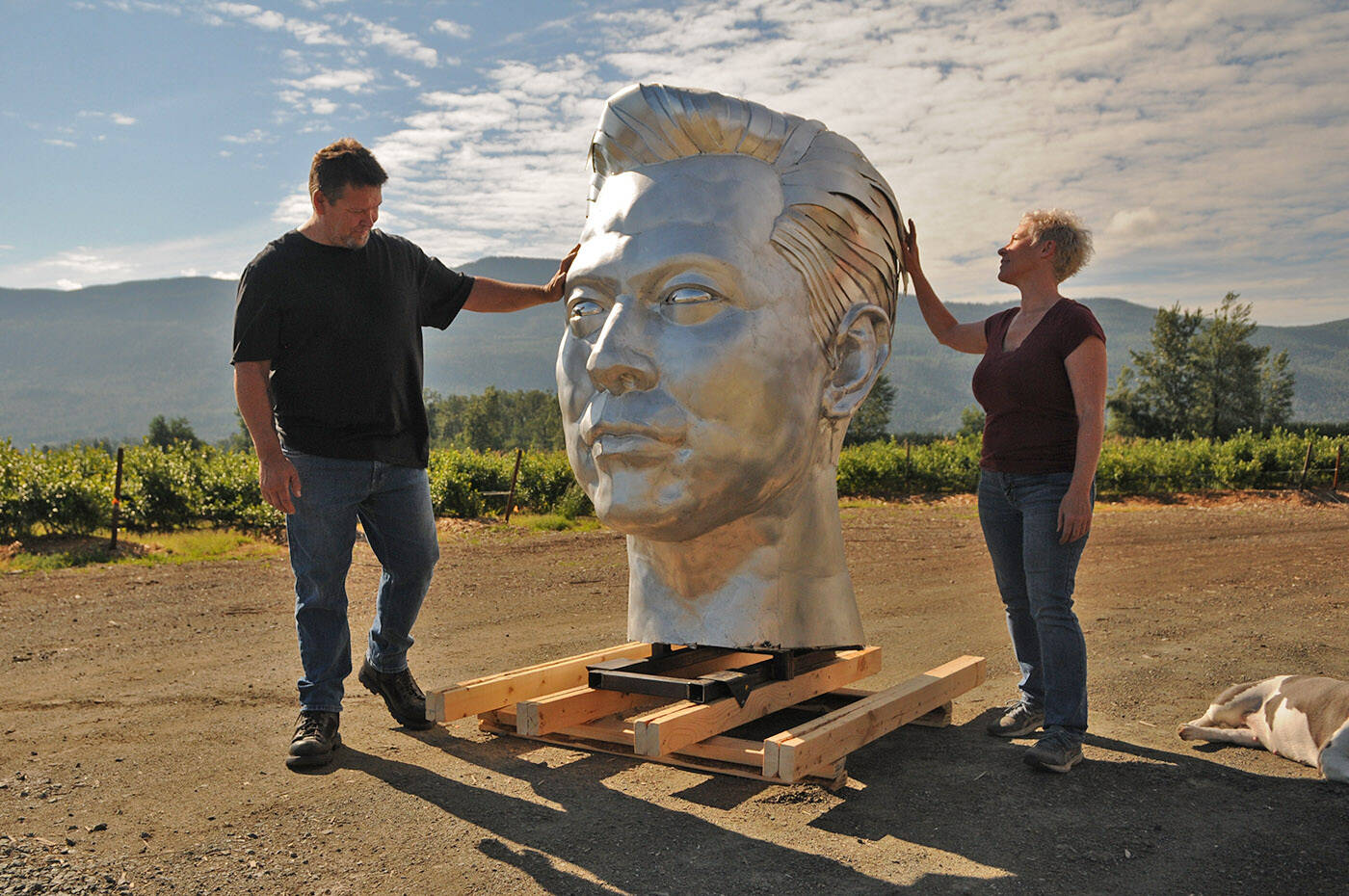 Kevin and Michelle Stone look at the 59 tall Elon Musk head that they worked on together. They are seen outside their workshop near Chilliwack on July 5, 2022. (Jenna Hauck/ Chilliwack Progress)