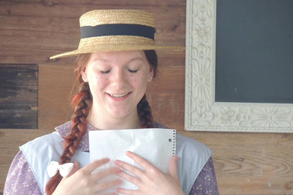 Anne Shirley reads from a story during Behind the Gate Theatre Company presentation of “Anne of Green Gables, A Summer Concert.” See more photos online at agassizharrisonobserver.com. (Adam Louis/Observer)