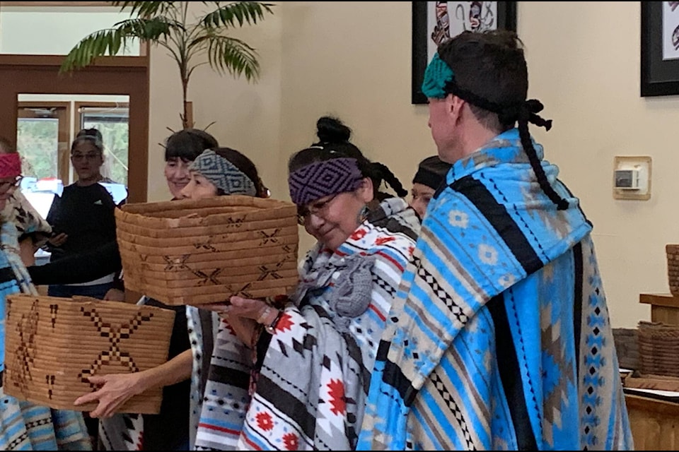 Claudette Leon reacts as she holds a repatriated Sts’ailes basket during a ceremony on Friday, March 3. A total of 29 baskets were returned to the Sts’ailes First Nation. (Adam Louis/Observer)