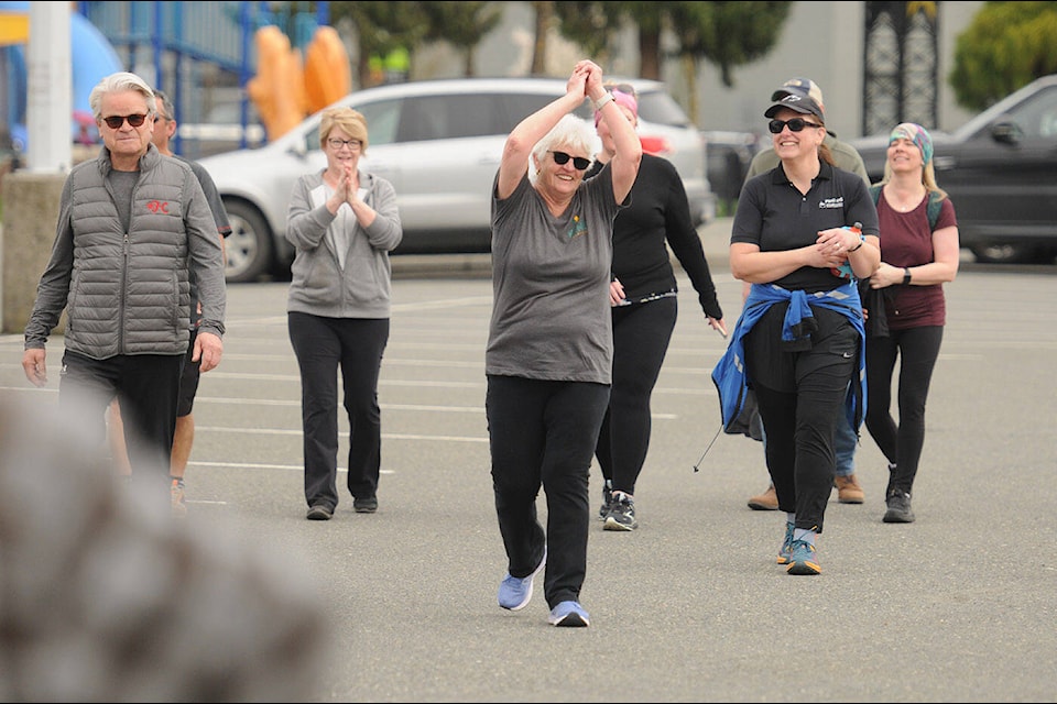 District of Kent Mayor Sylvia Pranger raises her arms in victory after completing a 26-kilometre walk from Agassiz to Chilliwack to raise awareness for the need for a year-round aquatic centre in Agassiz. (Jenna Hauck/ Chilliwack Progress)