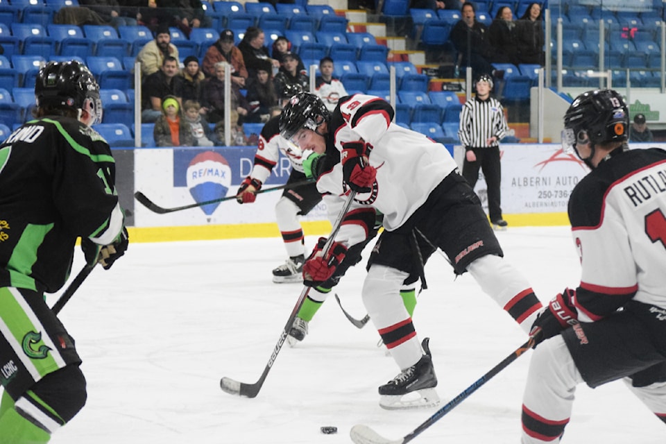 Port Alberni Bombers forwards Zach Spafford and Casey Rutland pass the puck back and forth in front of the Lake Cowichan net, leading to their first goal of the night.