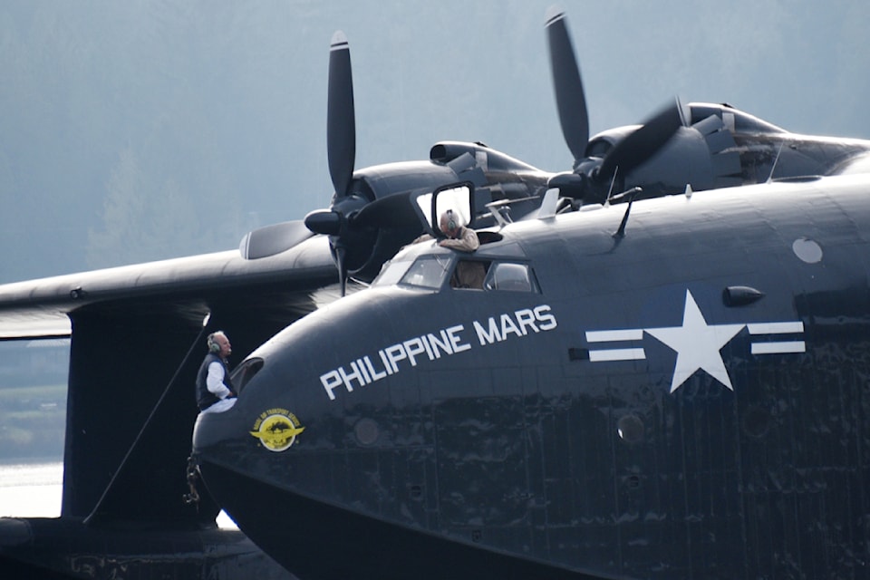 Flight engineer Dave Millman, left, and pilot Pete Killin are deep in conversation as they prepare to fire up the Philippine Mars on Sproat Lake Dec. 11, 2024. 
