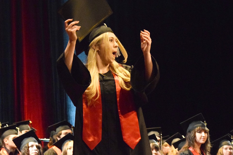 Graduate Maiya Turner shows off her diploma to the crowd during the ADSS graduation ceremony on June 27, 2024.