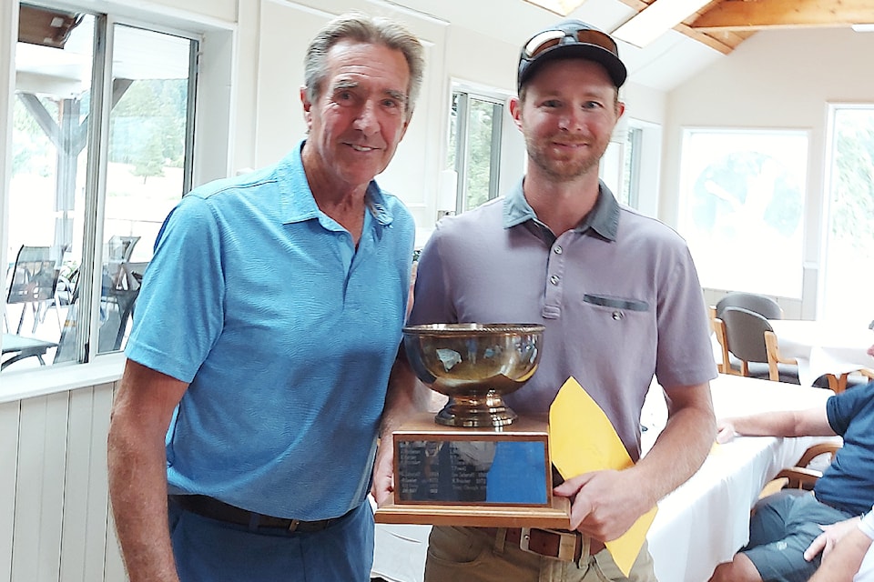 Mike Savard, right, is crowned the Alberni Golf Club champion after two days of golf action at the Port Albernin course, July 27-28, 2024. Savard accepts his trophy from president Ken Sander. 