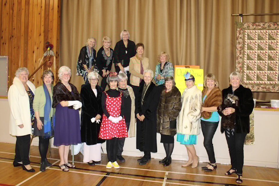 Models of the fashions from the Attic gathered at the close of the fashion show. Many wearing fur coats that will be going on sale in December.