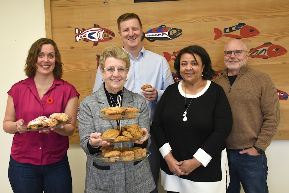 Healthy schools manager Kirsten Nesbitt, left, school board chair Pam Craig and Eighth Avenue Learning Centre principal Nick Seredick are ready to sample some of the Nourish breakfast cookies, scones and muffins that Fatima Da Silva and Rod Allen brought with them for an announcement on Oct. 31, 2024. 