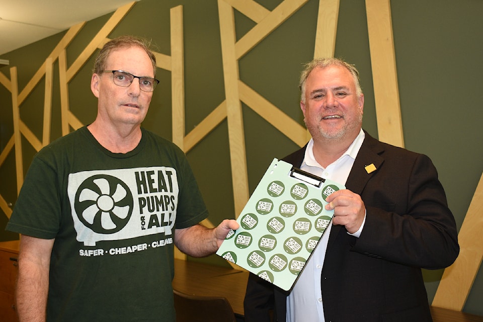 Mike Youds, left, of Port Alberni delivers a petition for a national heat pump strategy to Courtenay-Alberni MP Gord Johns in September 2024. 