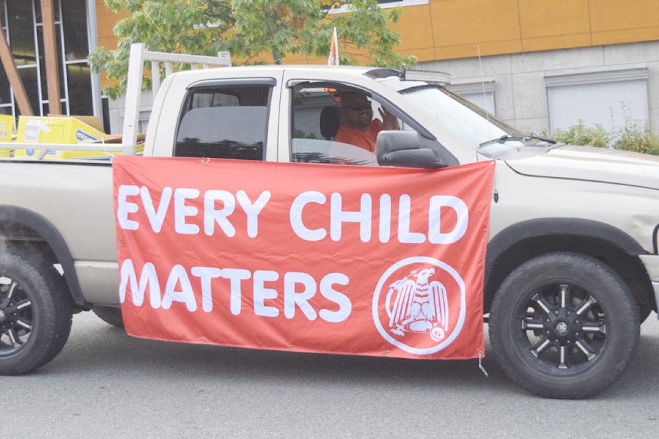 One of the pilot cars departs from ADSS for the Orange Shirt Day walk.
