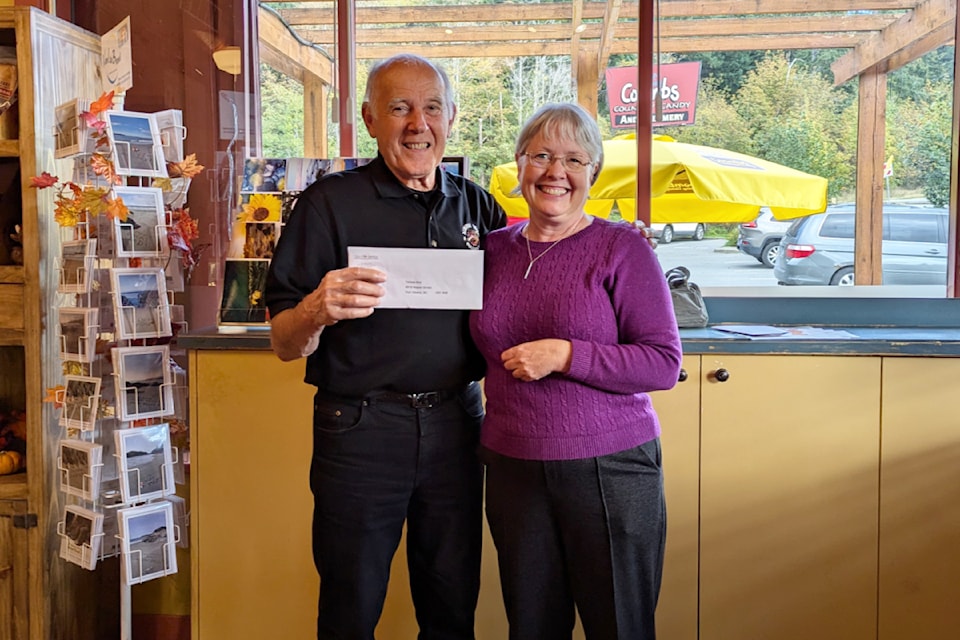 Alberni Valley News group publisher Teresa Bird gives Sam Frketich his prize.