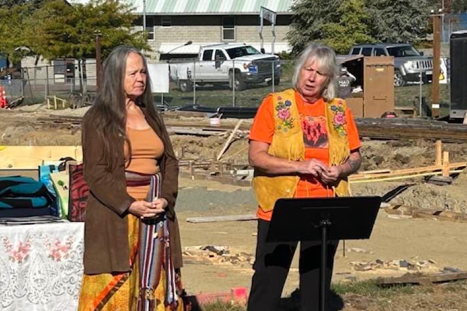 Alberni-Clayoquot Metis Society President June Graham and Metis Elder Fleurette Borsboom speak to the crowd gathered at Wood Elementary School.