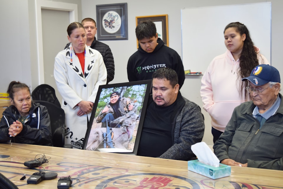 Patrick Charleson III speaks to the media on Thursday, Oct. 17 while holding a photo of his son.