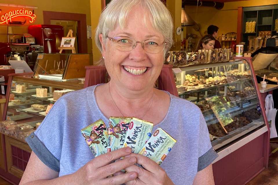Black Press Media group publisher Teresa Bird picks up Valley Vonka chocolate bars at Coombs Country Candy. Find the bars at participating sponsors and search for one of three golden tickets to win a prize package. 