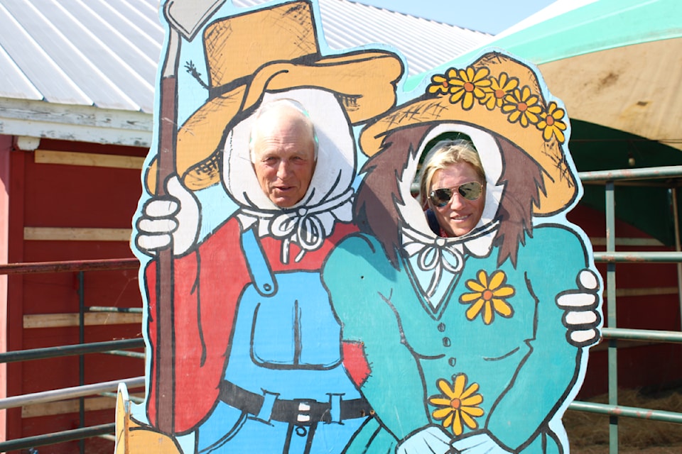 Farmer Bill Thomson and daughter Kasha pose in “Old Farmer Bills Farmyard,” which was moved to a new location this year. 