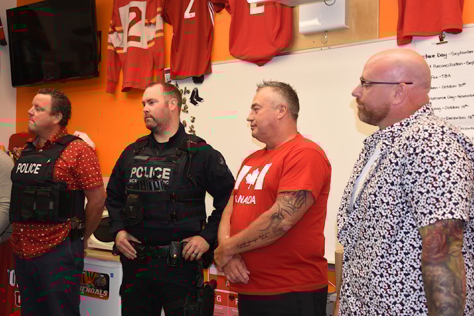 Port Alberni RCMP members Cpl. Aaron Aasen, left, Cpl. Jordan Hamlyn and former Port Alberni Const. Jamie Wasylien, right, help present ADSS athletic director Mike Roberts, second from right, with an RCMP Commanding Officer's Commendation on Sept. 13, 2024. 
