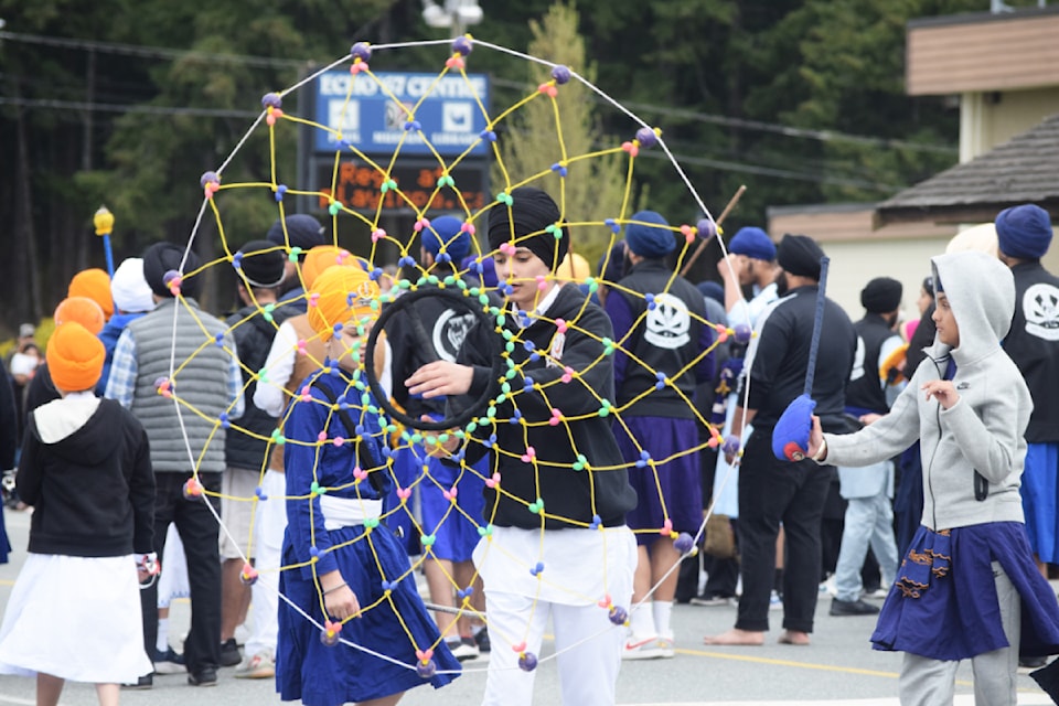 Gatka performers lead the parade down 10th Avenue in Port Alberni.