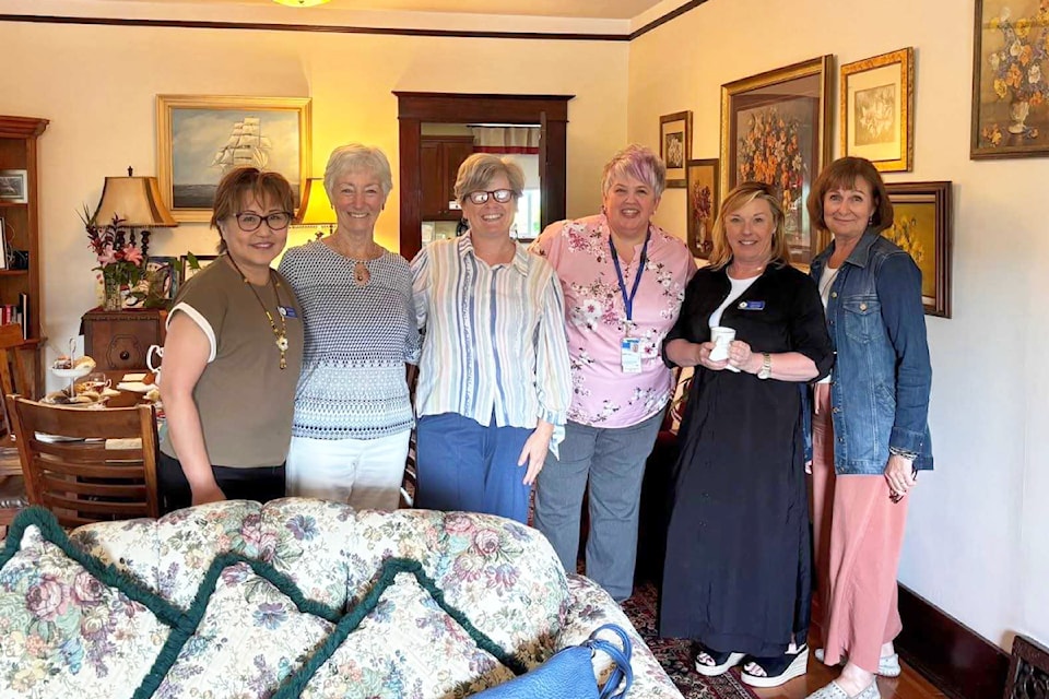 Ty Watson House staff and Hospice Society members give the minister of health a tour around Ty Watson House. From left: Kim Cameron (Ty Watson cook), Robyn Monrufet (former board chair), Josie Osborne (minister of health), Marylou Jarvis (palliative care nurse consultant), Moira McNeil (service coordinator), Nancy Wilmot (board chair).