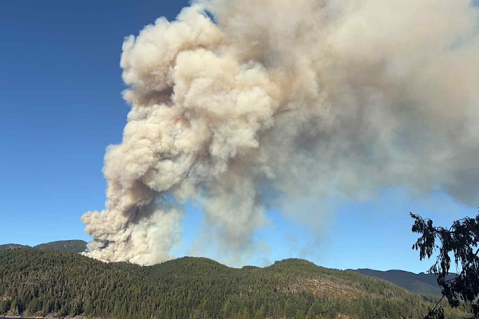Early photos taken from Macktush Campground, across the Alberni Inlet from the Bamfield Main fire, show a narrow plume of heavy smoke. (ALYSON SCHMITZ/ Alberni Valley News)