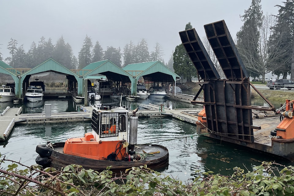 A workboat from Timberrose Tug and Barge maneuvres a barge into position during dredging Clutesi Haven Marina in Port Alberni, Wednesday, Jan. 29, 2025. 