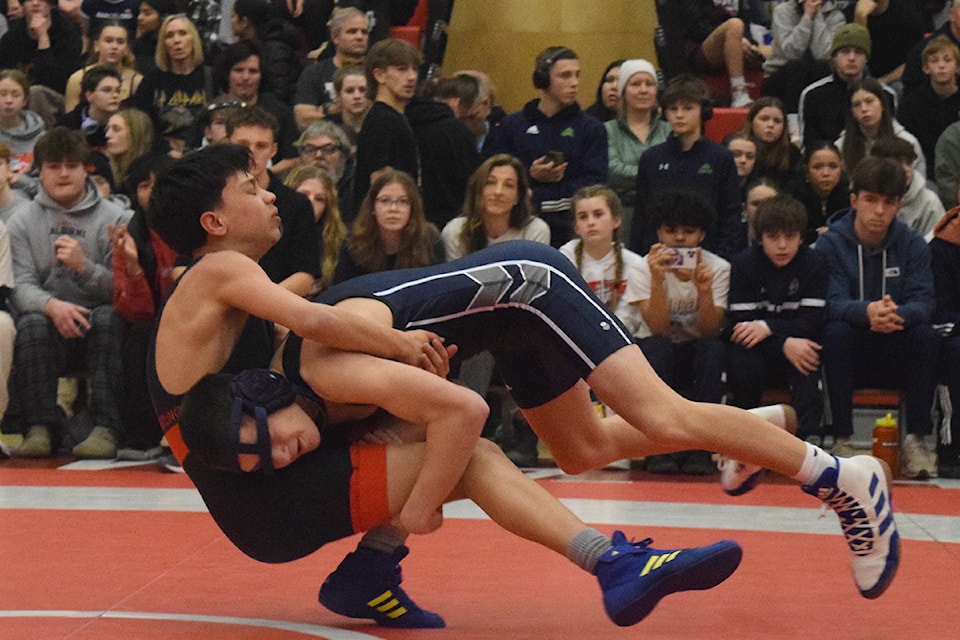 Port Alberni's Evan Jimenez is taken down by Gianluca Russo of Notre Dame Regional Secondary School in the 48kg junior male final.
