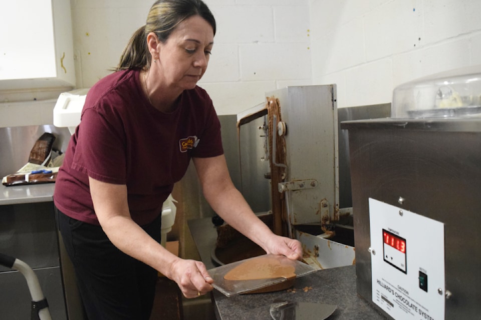Shelley Birch, a chocolatier with Coombs Country Candy, prepares a heart-shaped chocolate mold for Valentine's Day.