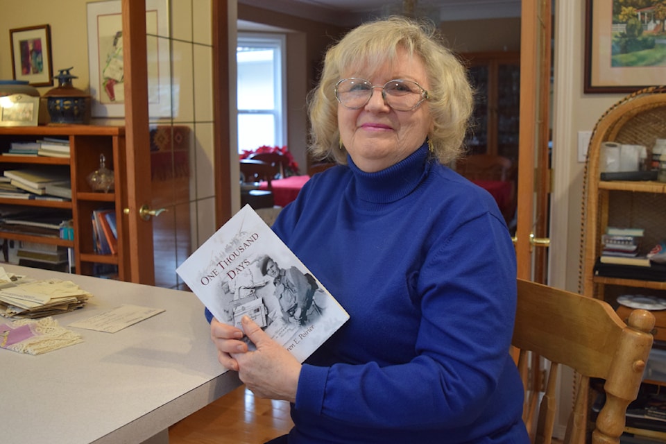 Karen Poirier shows off a copy of her newest novel, One Thousand Days.