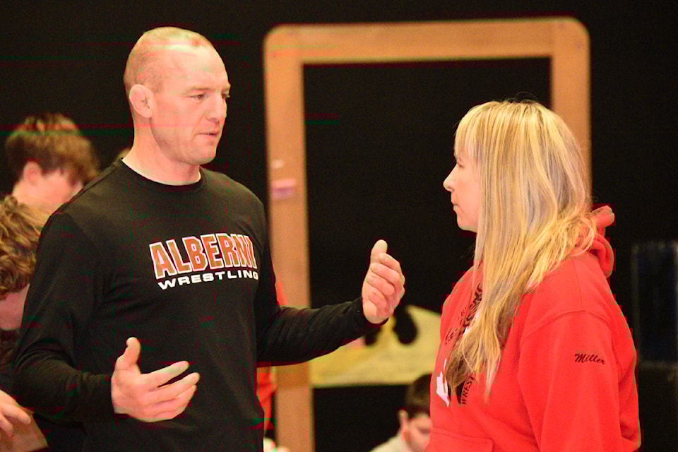 Alberni Wrestling coaches Travis Cross and Maureen Miller discuss the program for a wrestling practice at Alberni District Secondary School in January 2025. The duo once wrestled in the upcoming Alberni Invitational and are now coaching their own children in the event. 