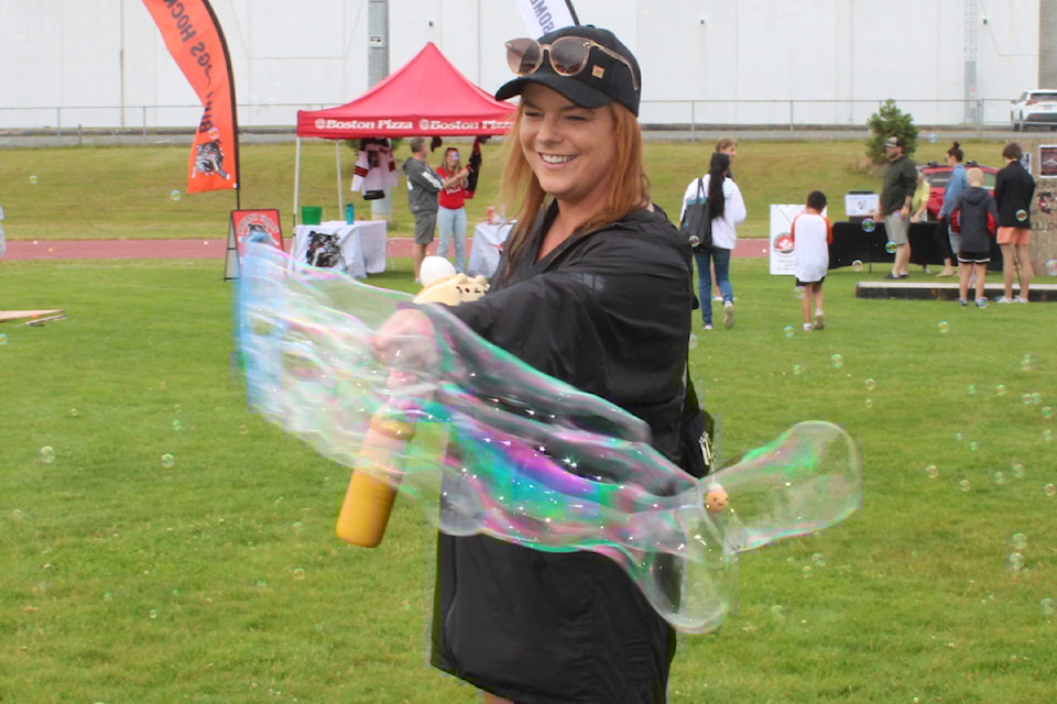 Jessica Rogers couldn’t resist playing with the bubbles during the Parks, Recreation and Culture department's annual Summer Kick-off, Friday, June 20, 2025 at Bob Dailey Stadium. (SONJA DRINKWATER/ Alberni Valley News)
