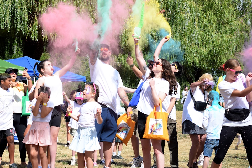 Colour Fest participants throw their coloured powder packages into the air to mark the start of the event on Saturday, July 19, 2025. (ELENA RARDON/ Alberni Valley News)