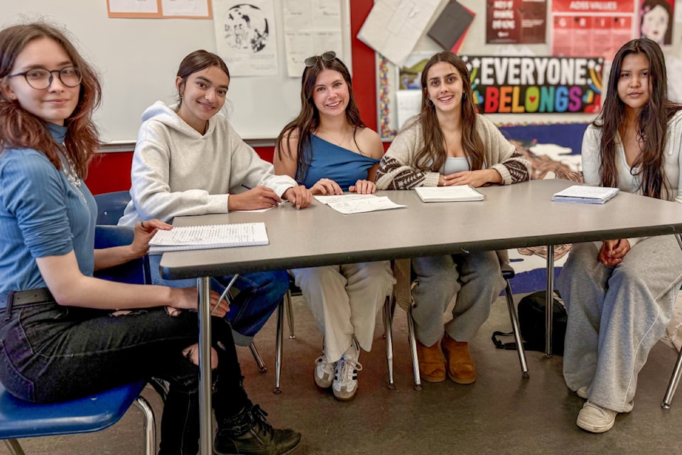 Students from Anne Ostwald's Social Justice class at Alberni District Secondary School, from left, Hannah Banford, Jenelle Kozlowski, Ella Freethy, Amaya Parmar and Kirsta Samuel work on a Cathedral Grove traffic project. 