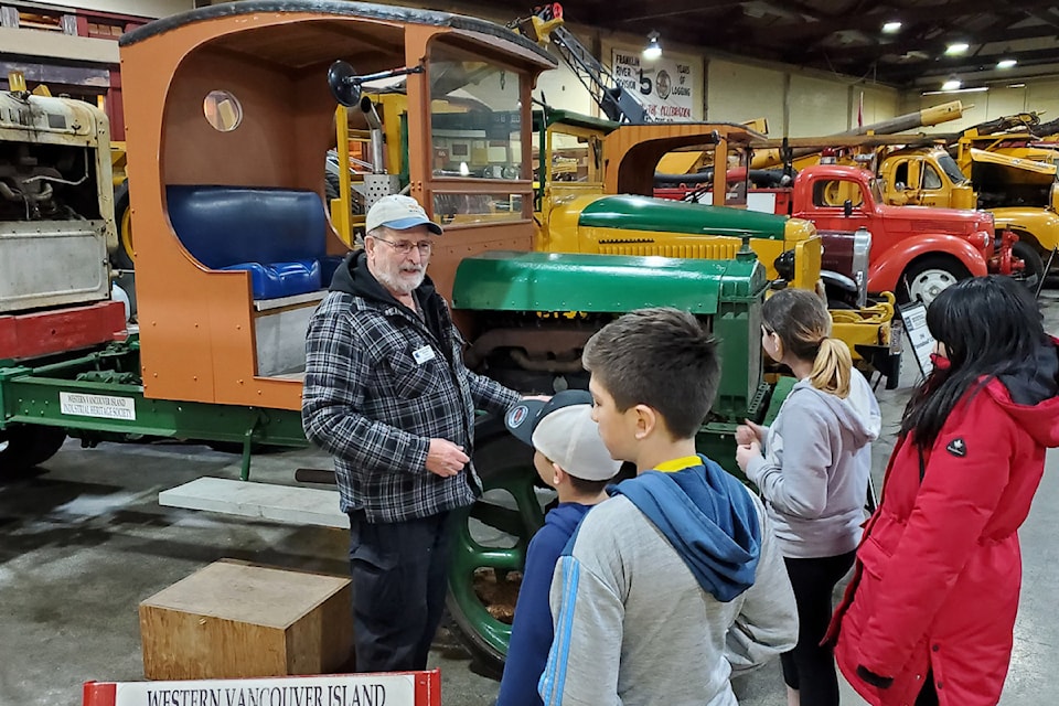 Ted Mollet from the IHS (and also Alberni Pacific Railway) shows visiting students the oldest truck on display at the Industrial Heritage Centre, a 1918 White Model truck. (FACEBOOK PHOTO)