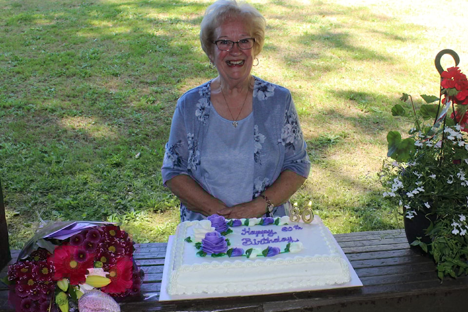 Jeanette Salsman with her special 80th birthday cake, during a celebration at Rogers Creek Park. (SONJA DRINKWATER/ Alberni Valley News)