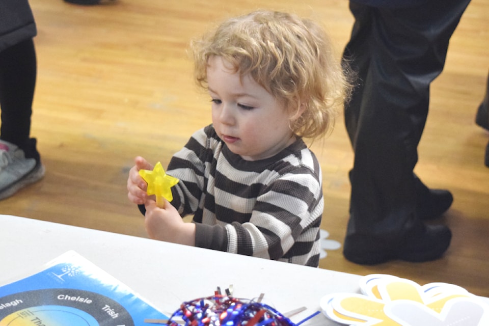 Yarrow Benoit checks out some of the free swag at the registration table during Coldest Night of the Year on Feb. 22, 2025.
